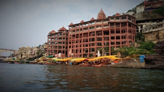 a large building sitting on the side of a river