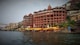 a large building sitting on the side of a river