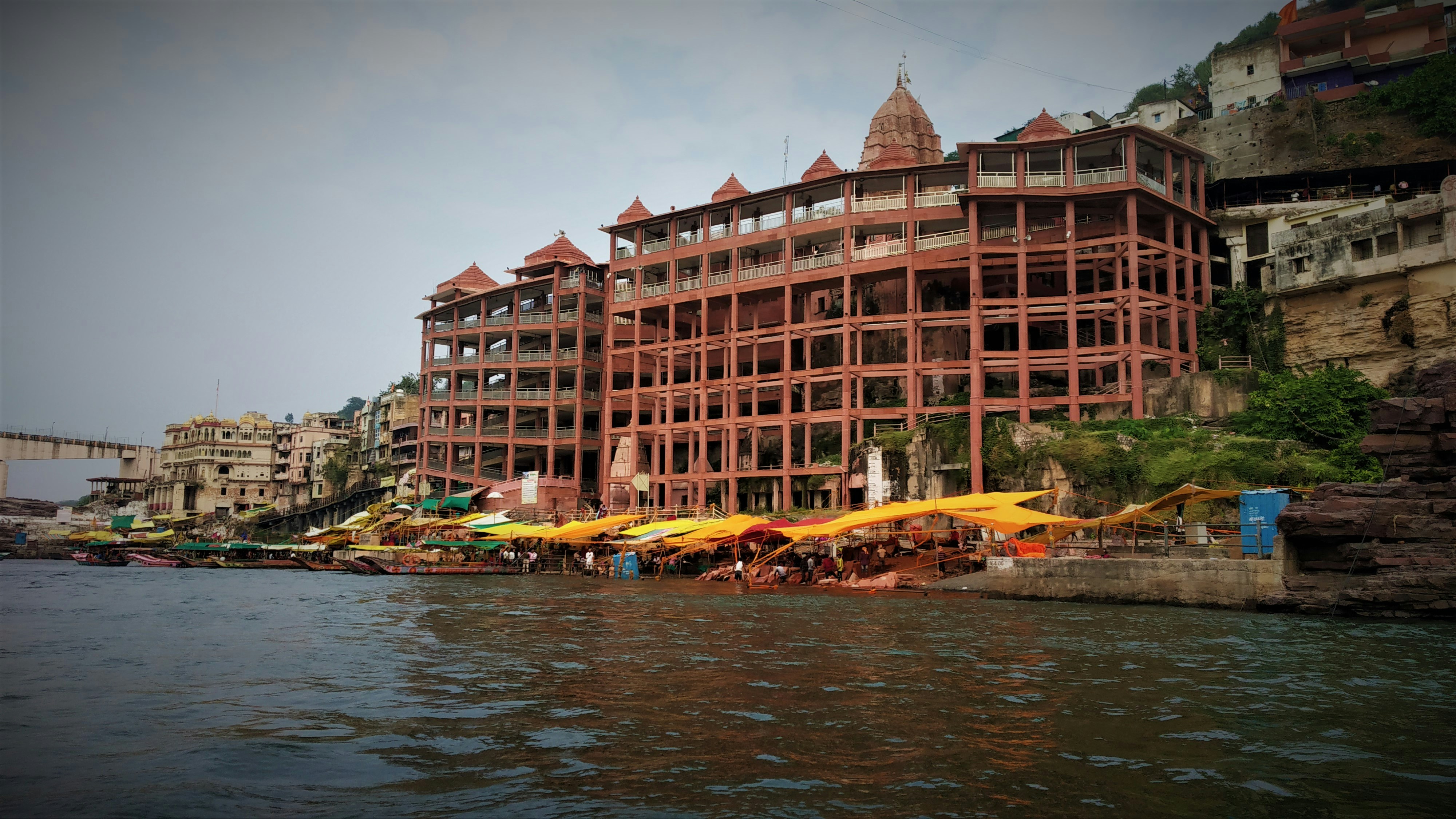 a large building sitting on the side of a river