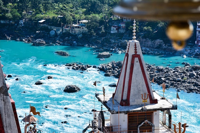 The serene Sarayu River flowing gently beside ancient temples at sunrise.