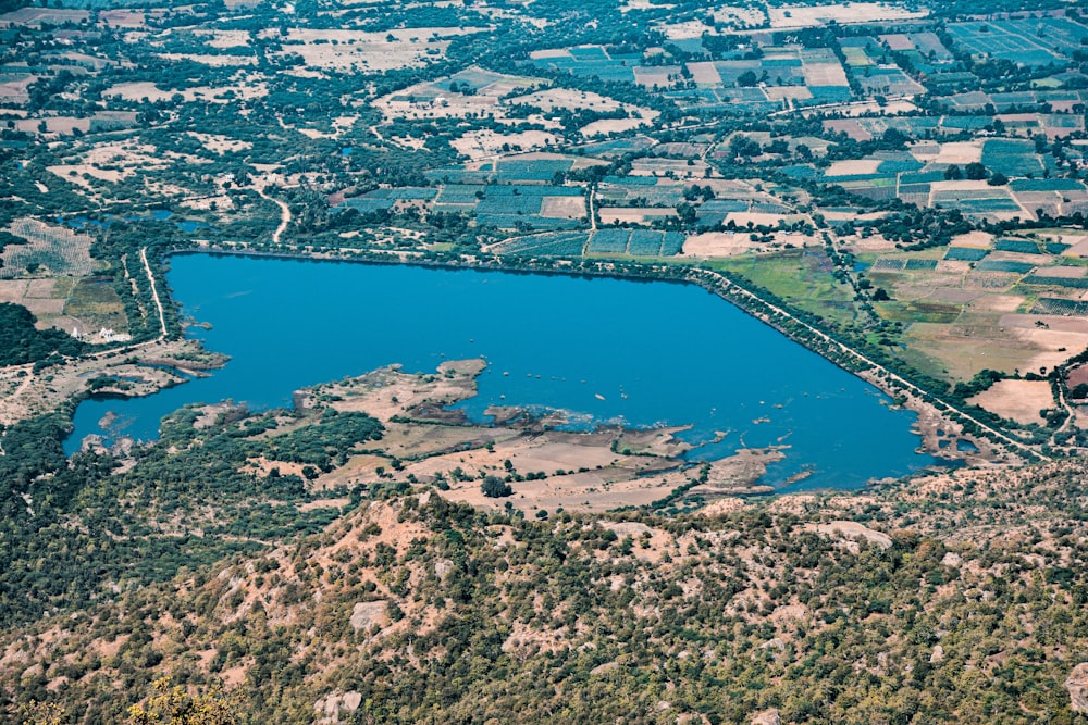 an aerial view of a lake surrounded by land