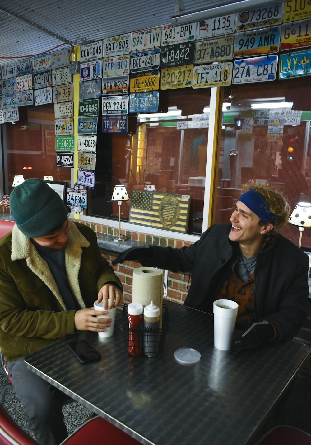 two men sitting at a table in a restaurant