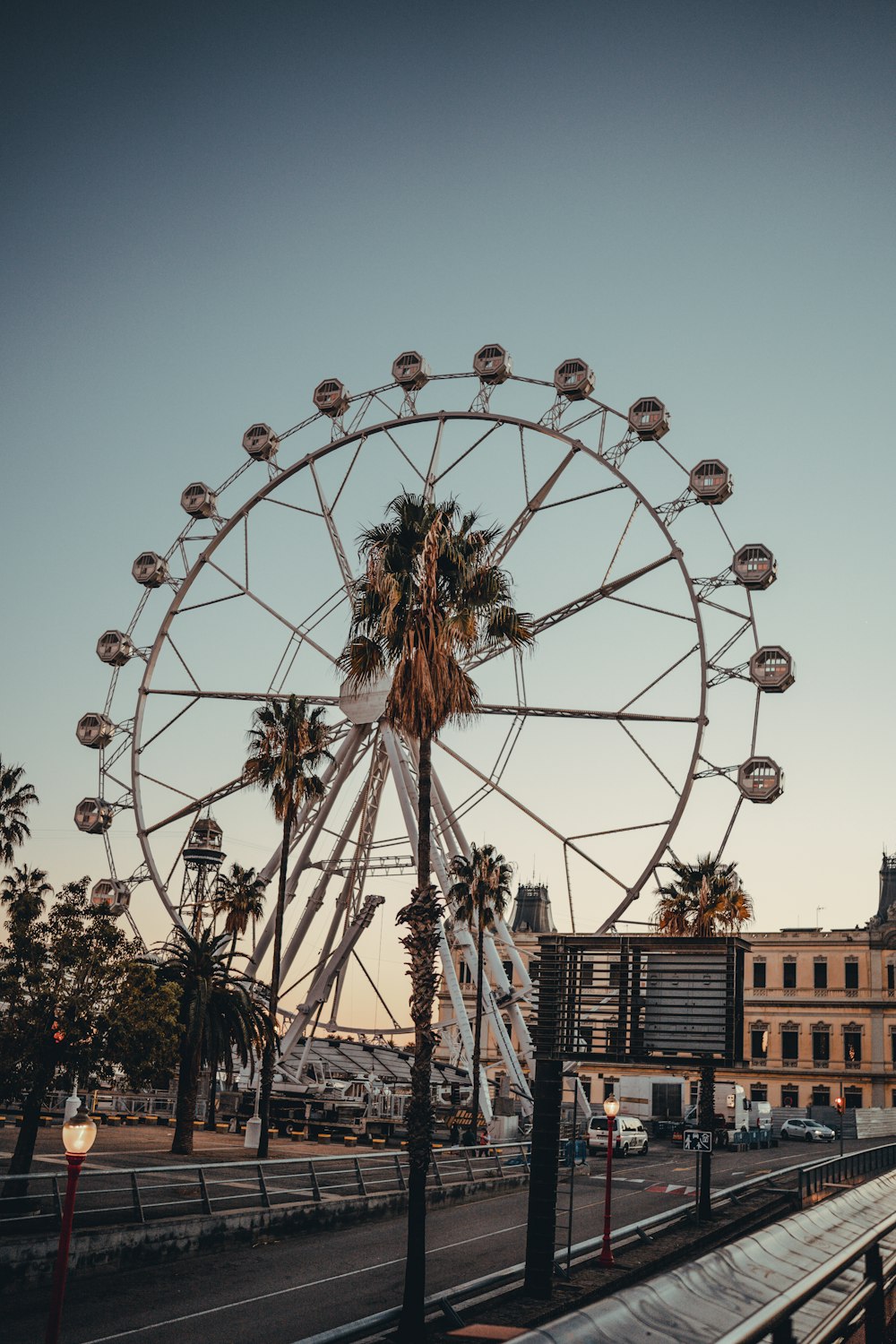 a large ferris wheel sitting on the side of a road