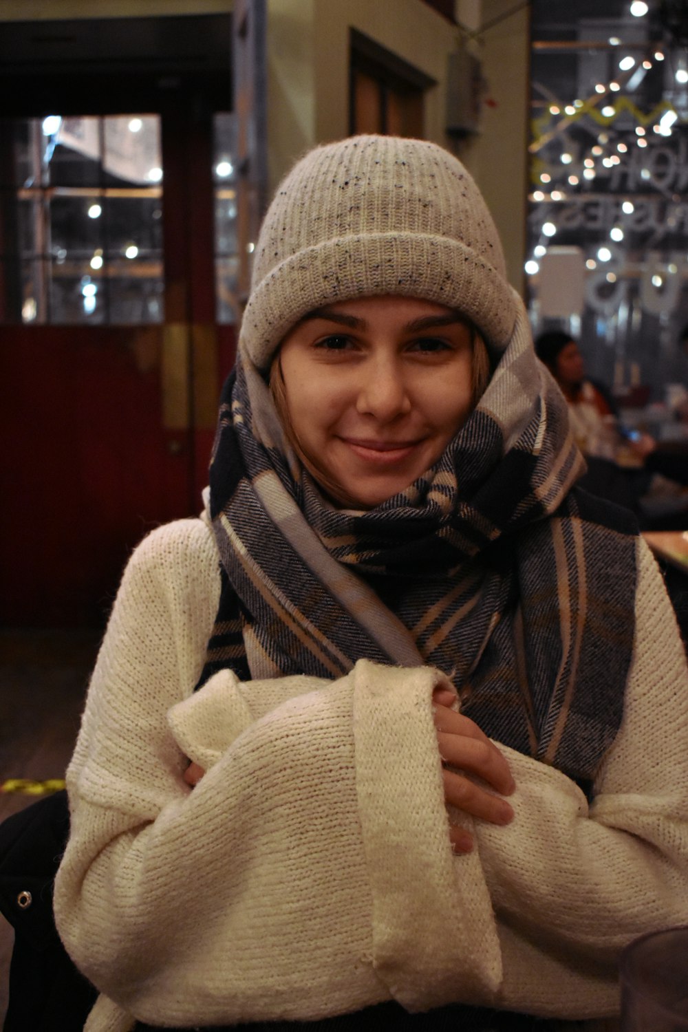 a woman wearing a scarf and a scarf around her neck