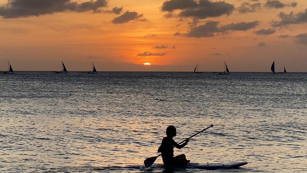 a person riding a surf board on a body of water