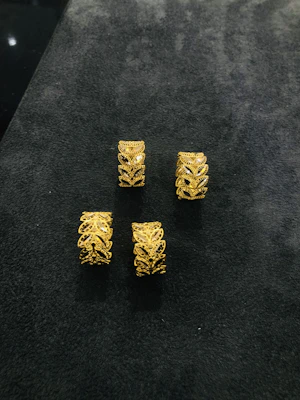 Elegant gold rings stacked together with intricate designs and gemstones.
