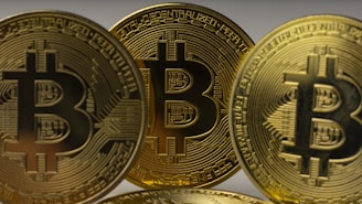 a pile of gold bitcoins sitting on top of each other