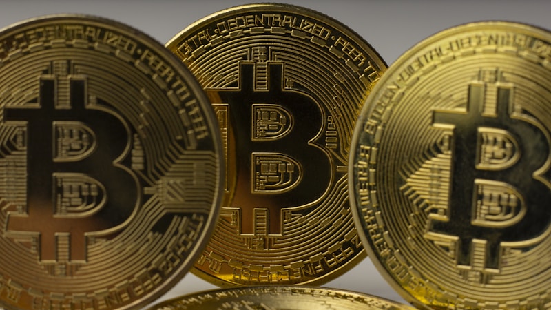 Bitcoin and gold coins on dark background