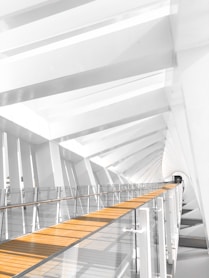 a white building with a wooden floor and stairs