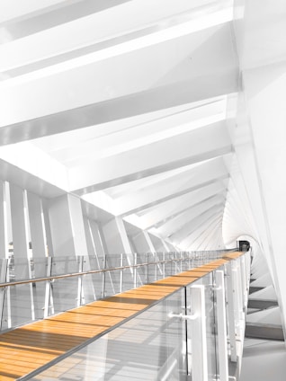 a white building with a wooden floor and stairs