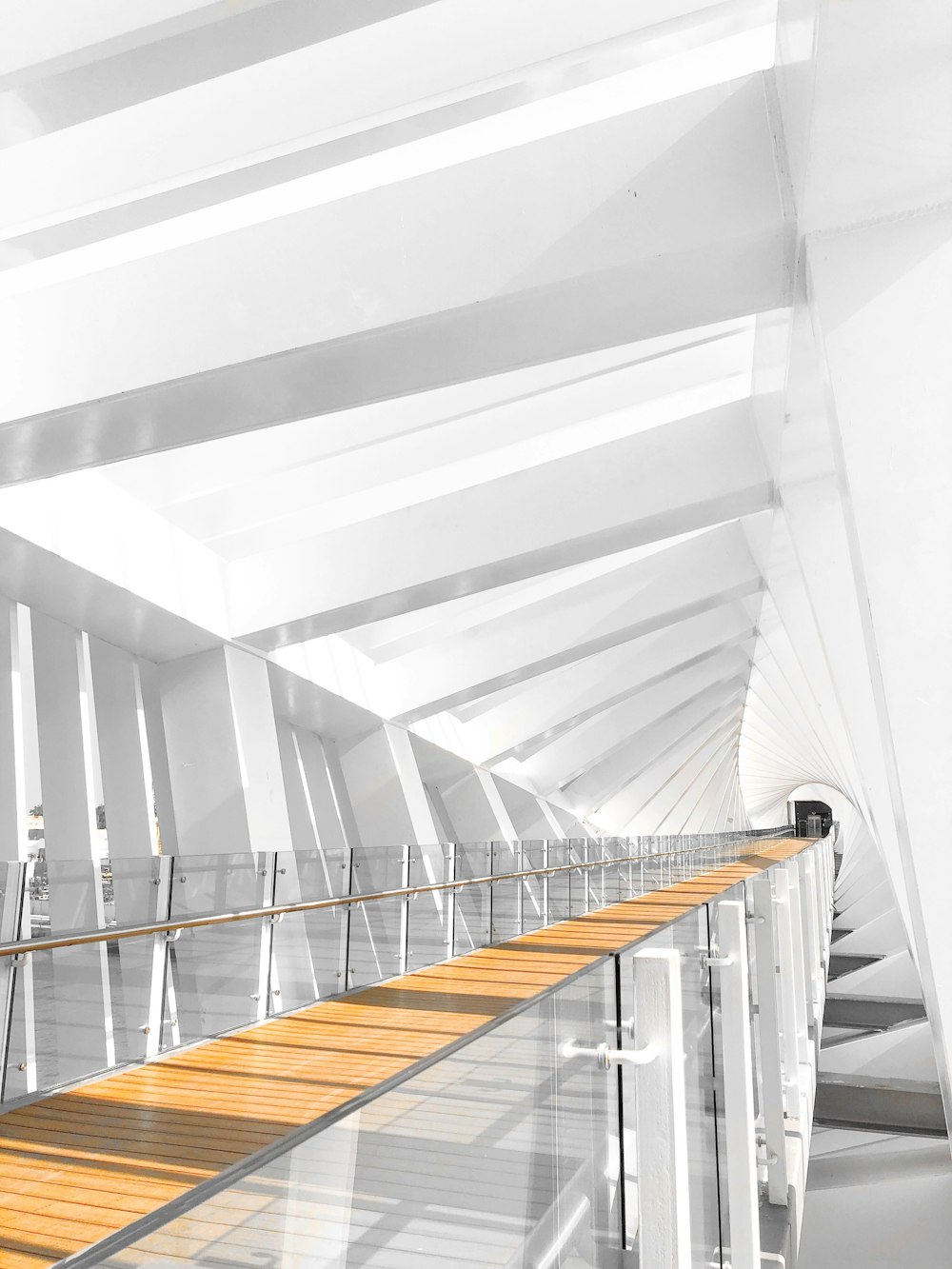 a white building with a wooden floor and stairs