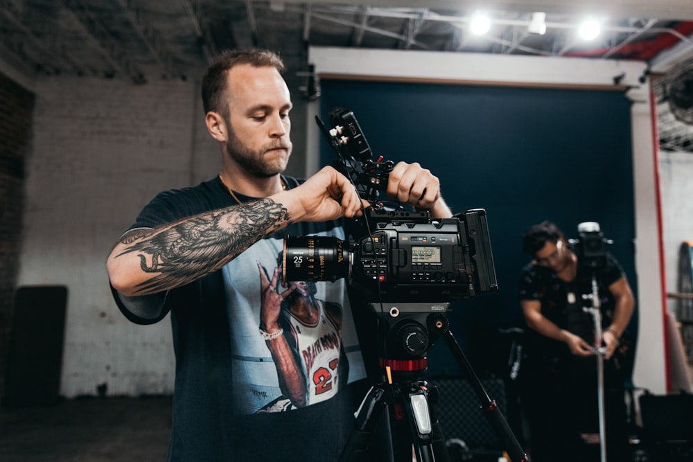 a man holding a camera in front of a camera