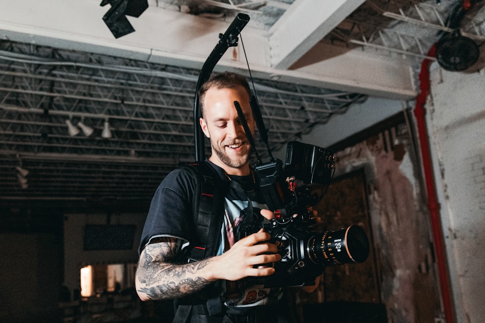 a man holding a camera in a room