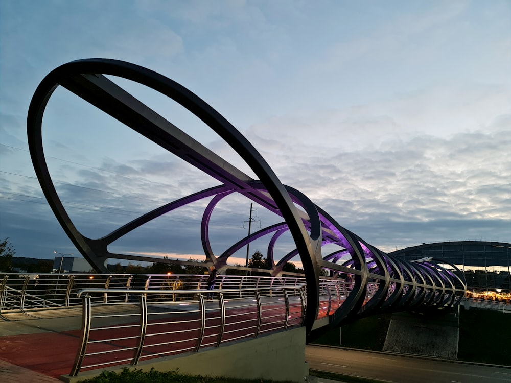 a large metal sculpture sitting on the side of a road