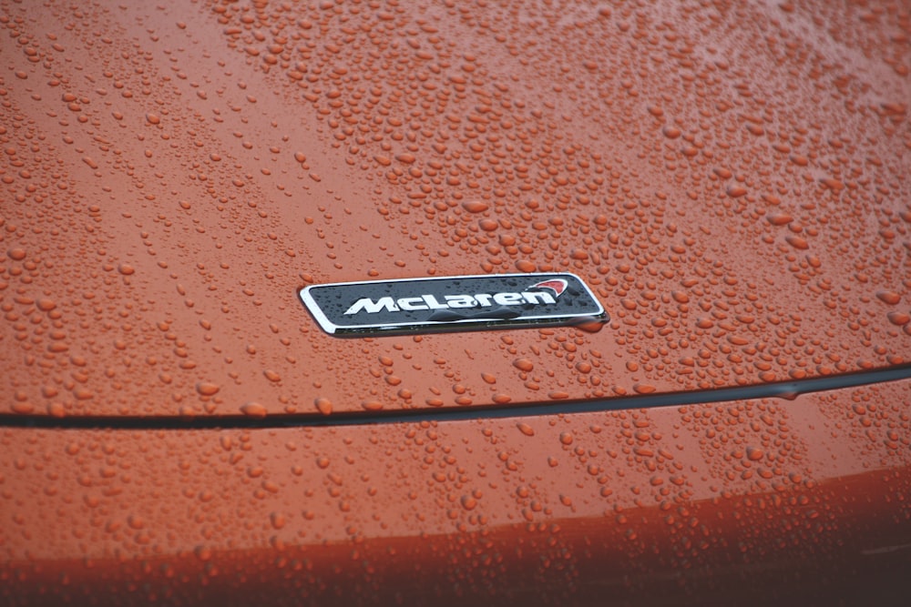 a close up of a car with water droplets on it