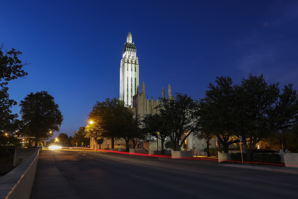 a large clock tower towering over a city at night