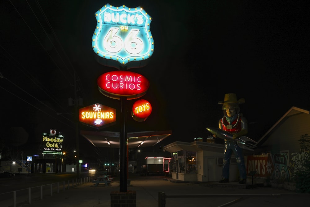 a neon sign for a gas station at night