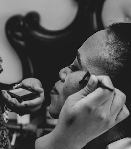 a woman is getting her make up done