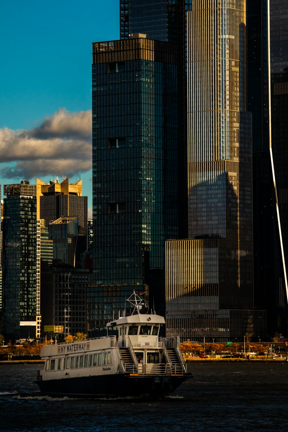 a boat in the water in front of a large city