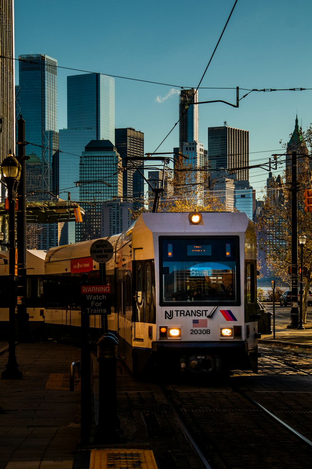 a train on a train track in front of a city skyline