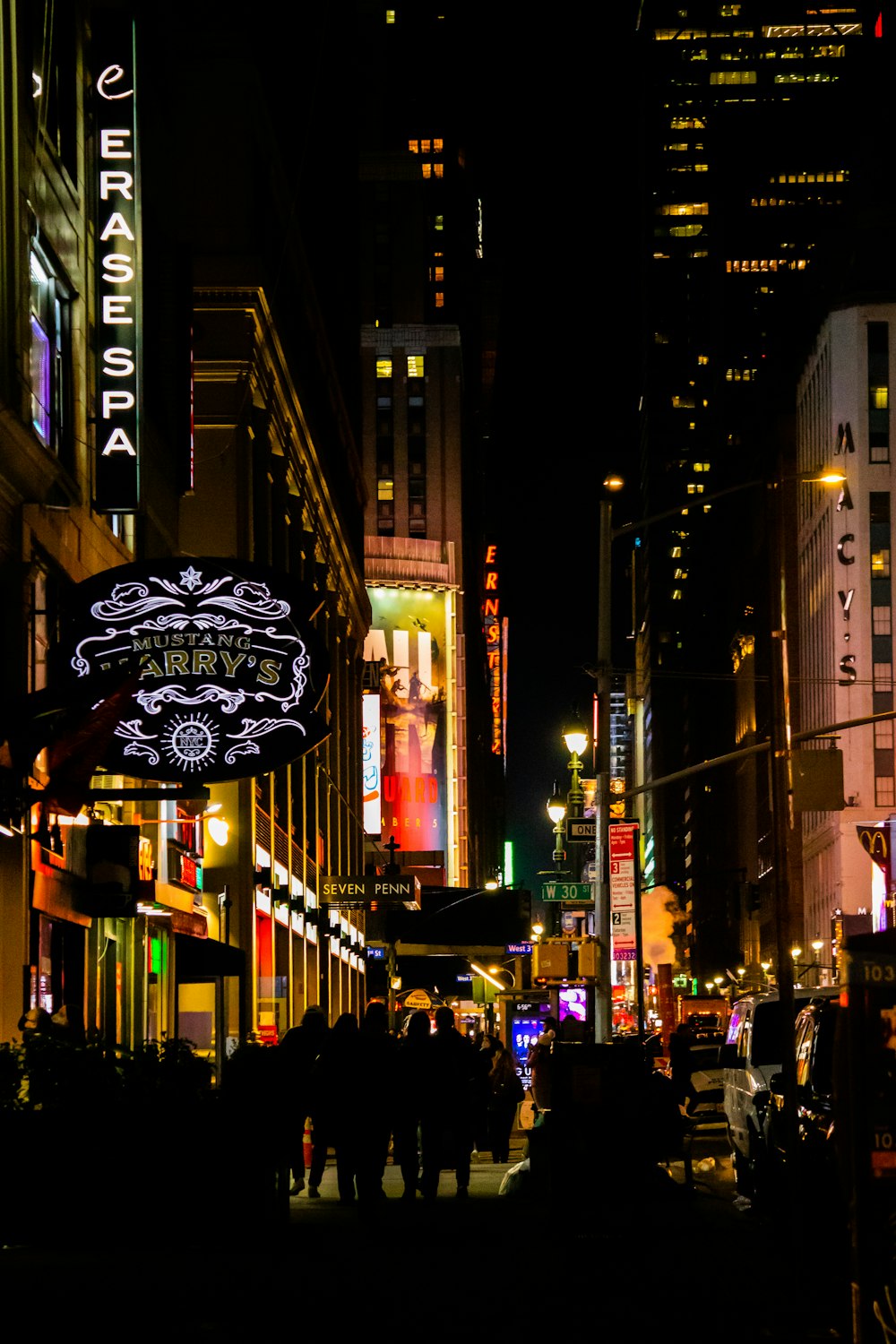 a busy city street at night with neon signs