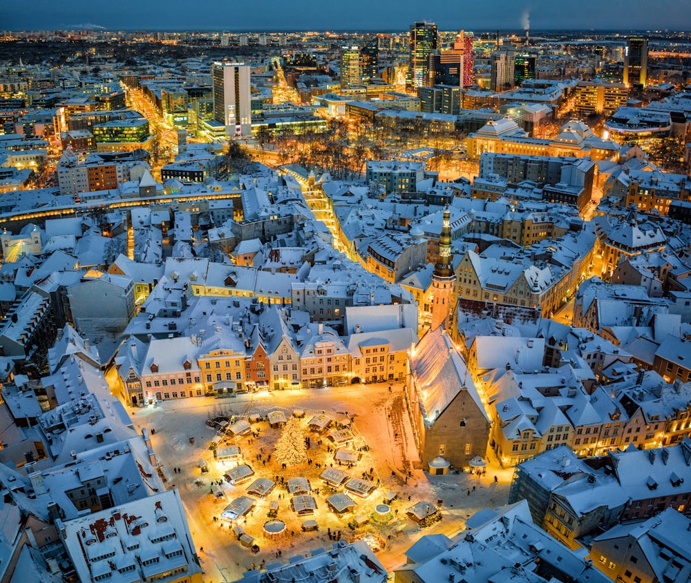 an aerial view of a snowy city at night