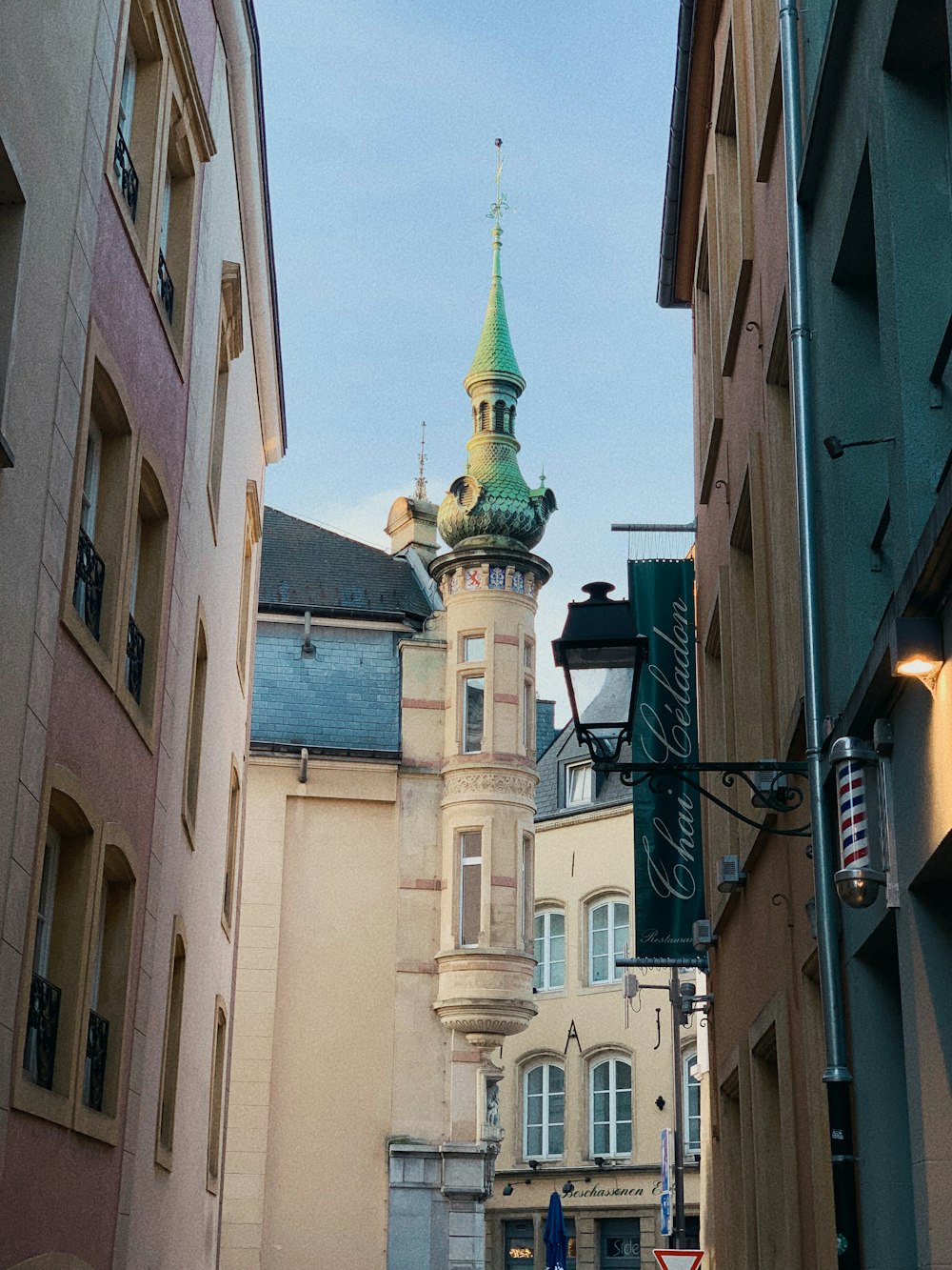 a tall building with a green steeple on top of it
