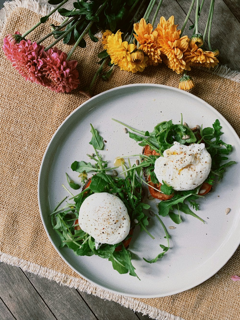 a white plate topped with two eggs on top of lettuce