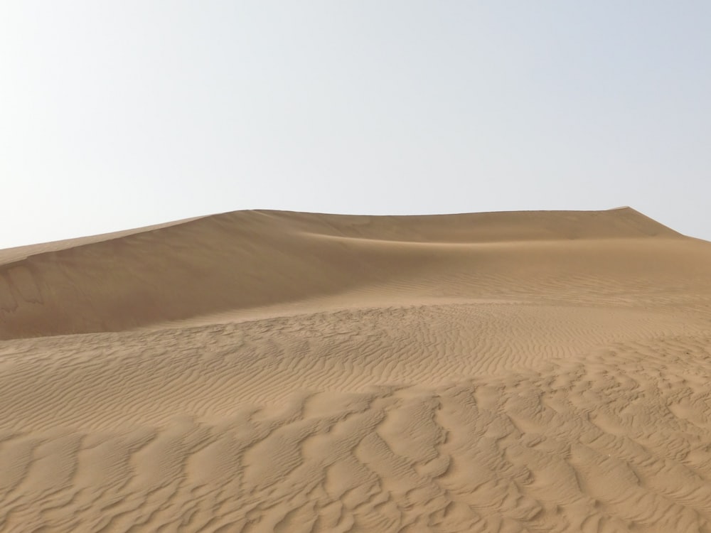 a large sand dune in the middle of a desert