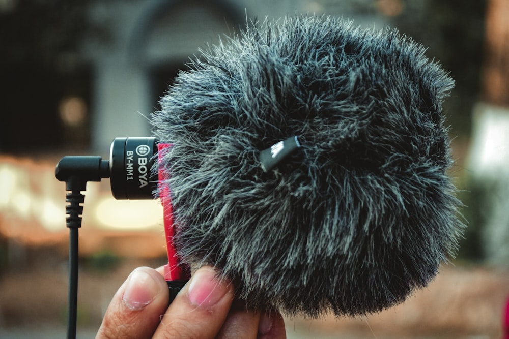 a close up of a person holding a microphone