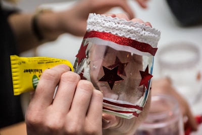 a person holding a wine glass with a red star on it