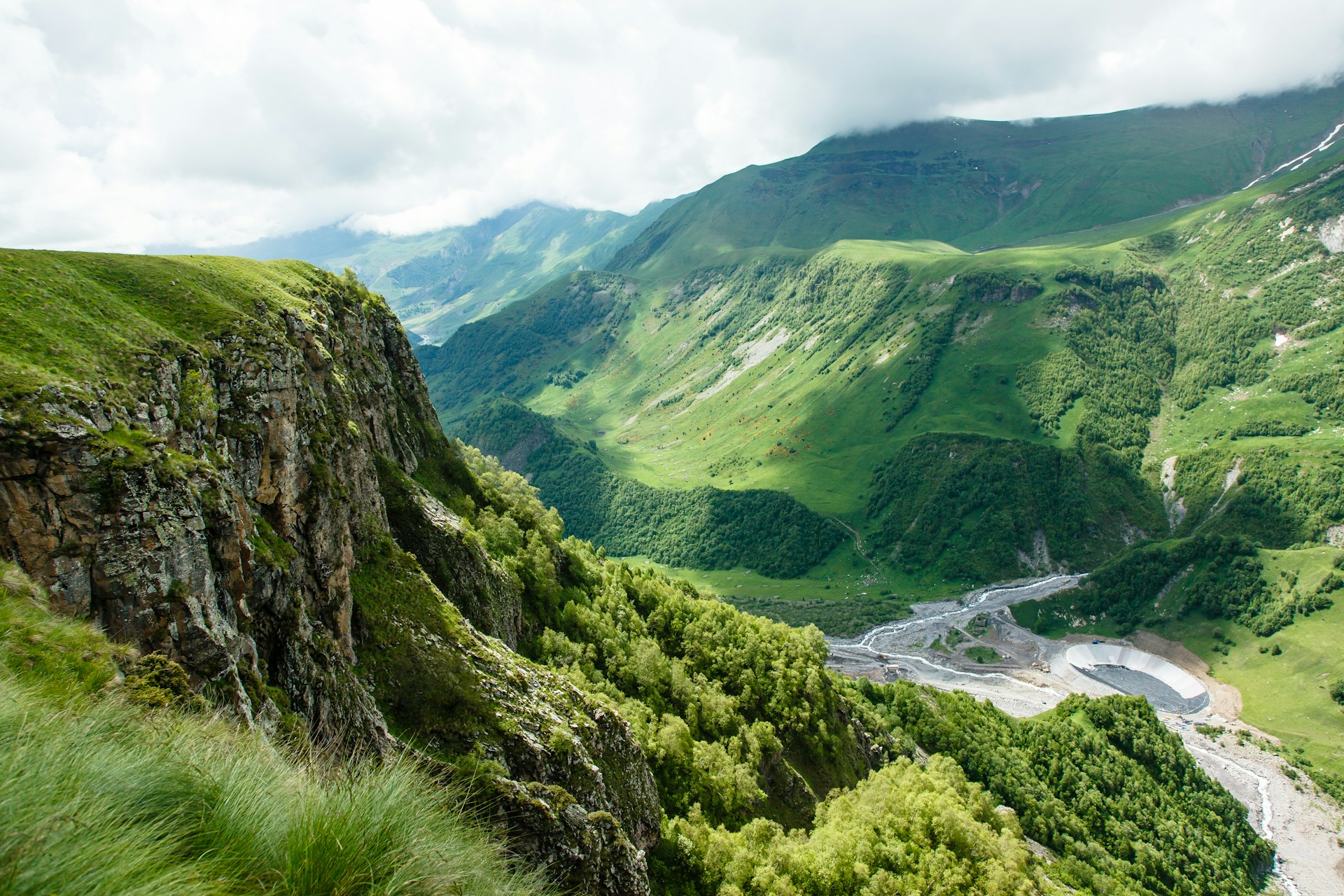 a view of a valley with a river running through it