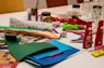 a table topped with lots of craft supplies