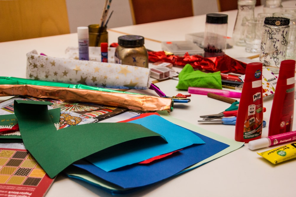 a table topped with lots of craft supplies