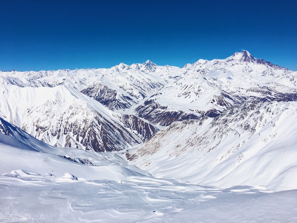 a view of a snowy mountain range from a ski slope