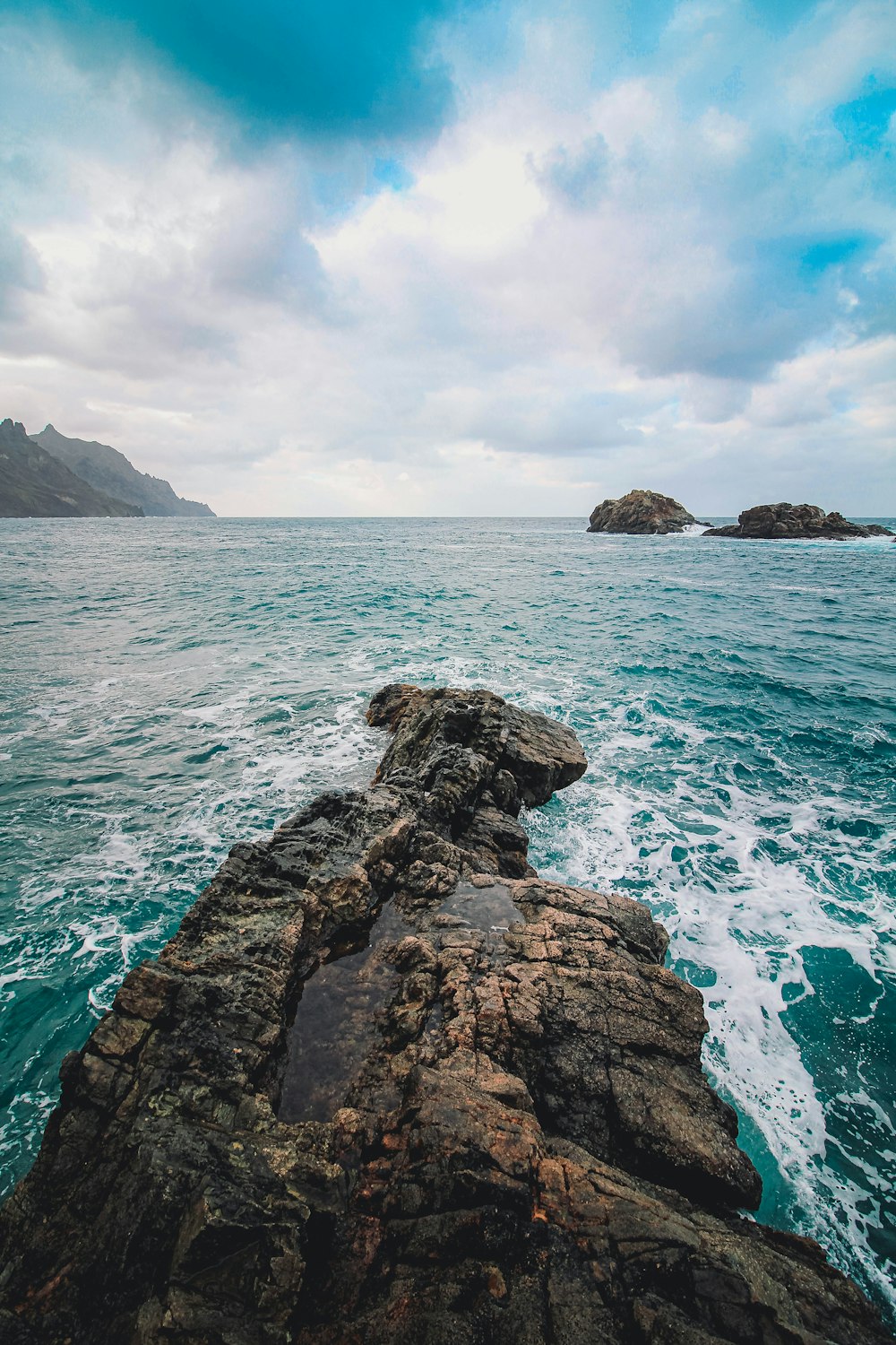 a rocky outcropping in the middle of the ocean