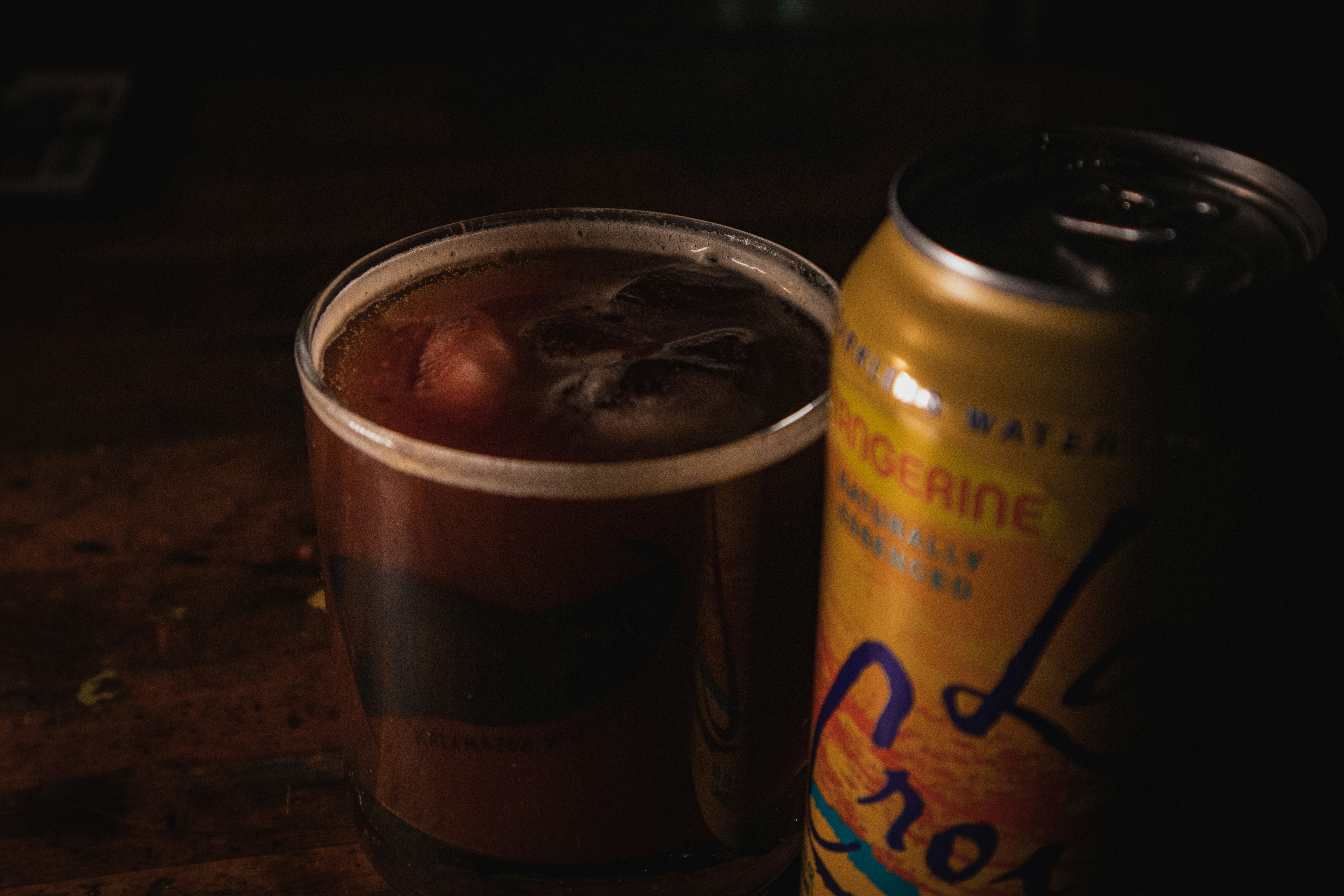 a can of orange juice next to a drink