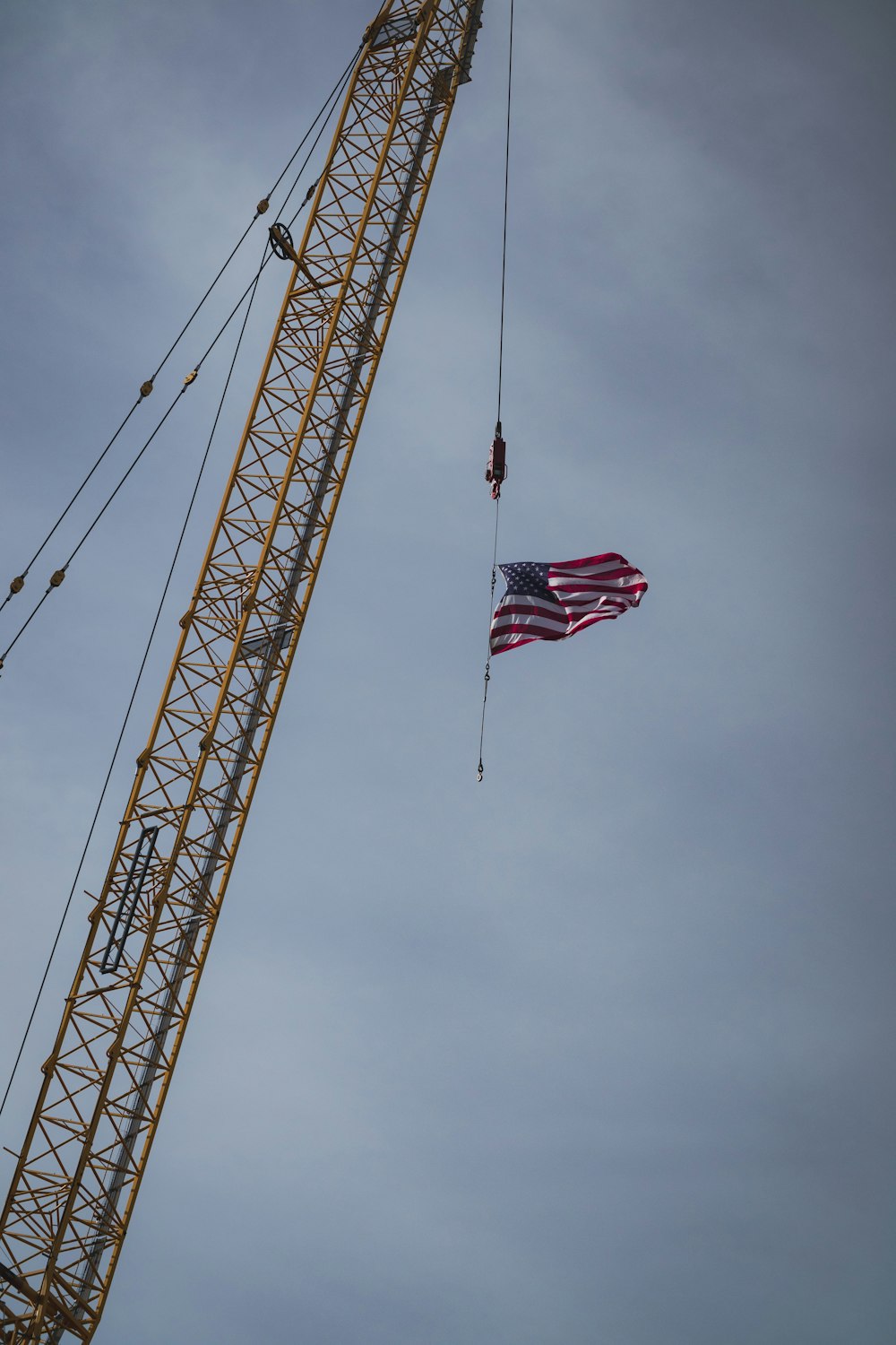 an american flag is being lowered from a crane