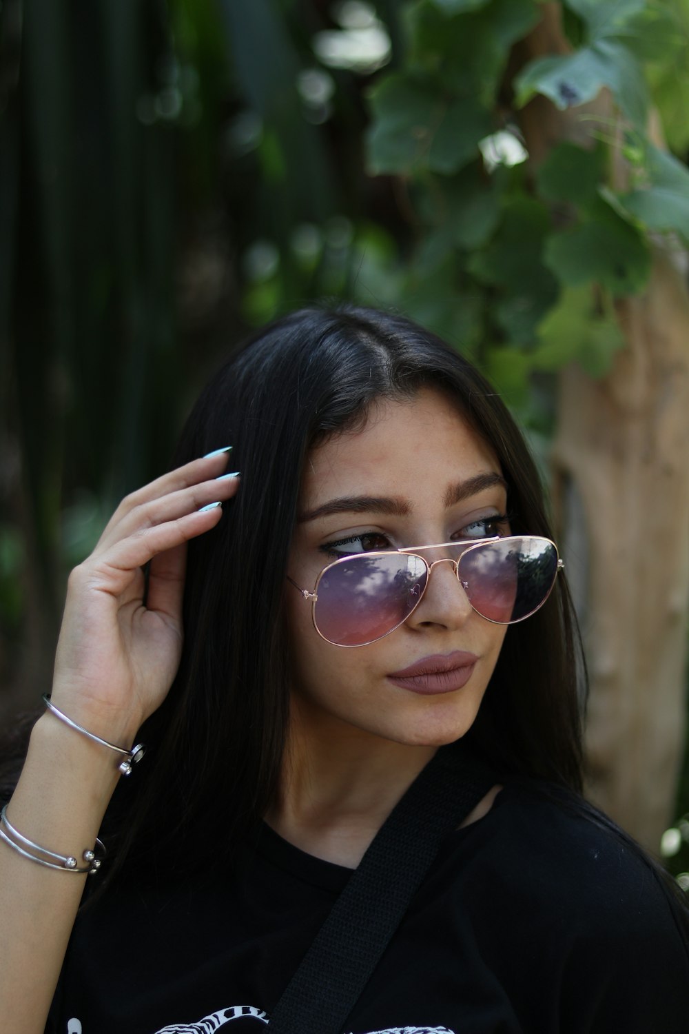 a woman wearing sunglasses and a black shirt