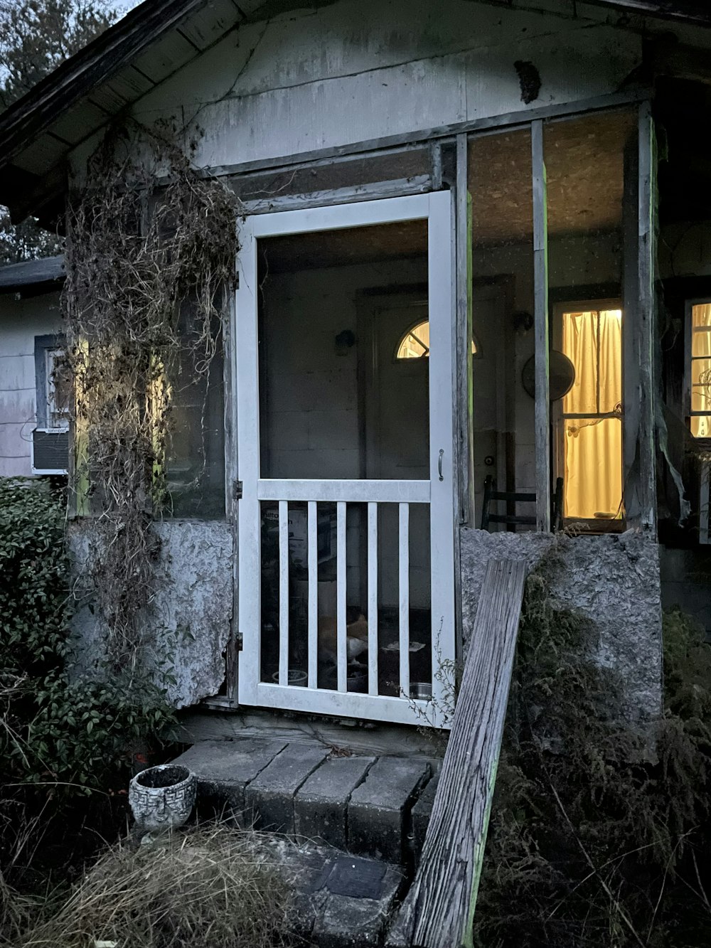 an old run down house with a porch