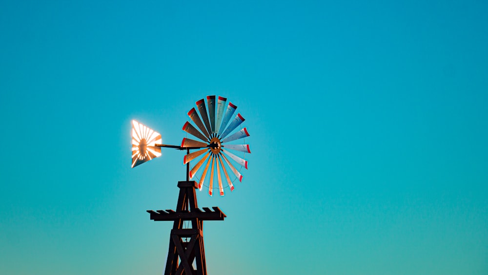 a windmill with a blue sky in the background