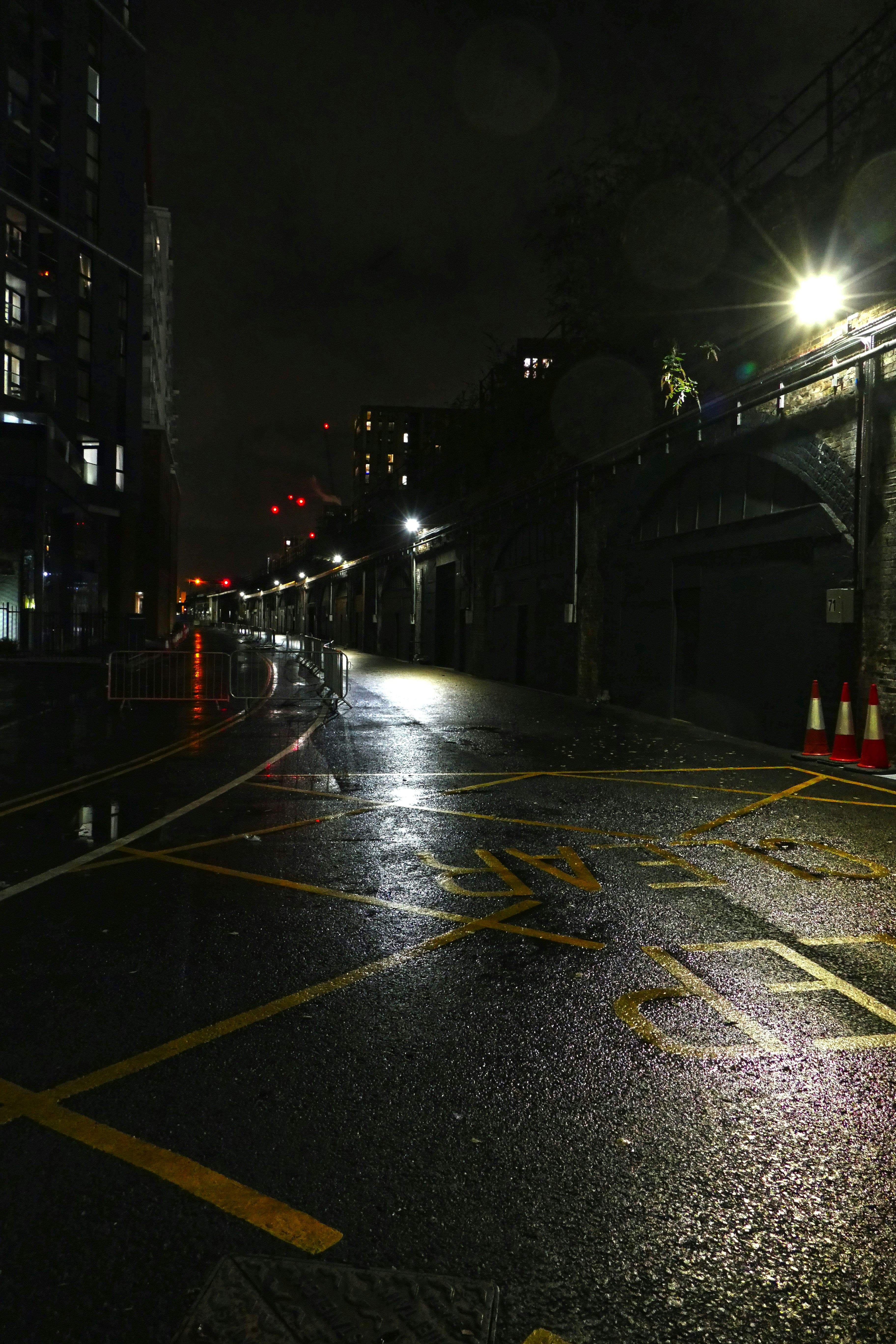 a city street at night with traffic lights