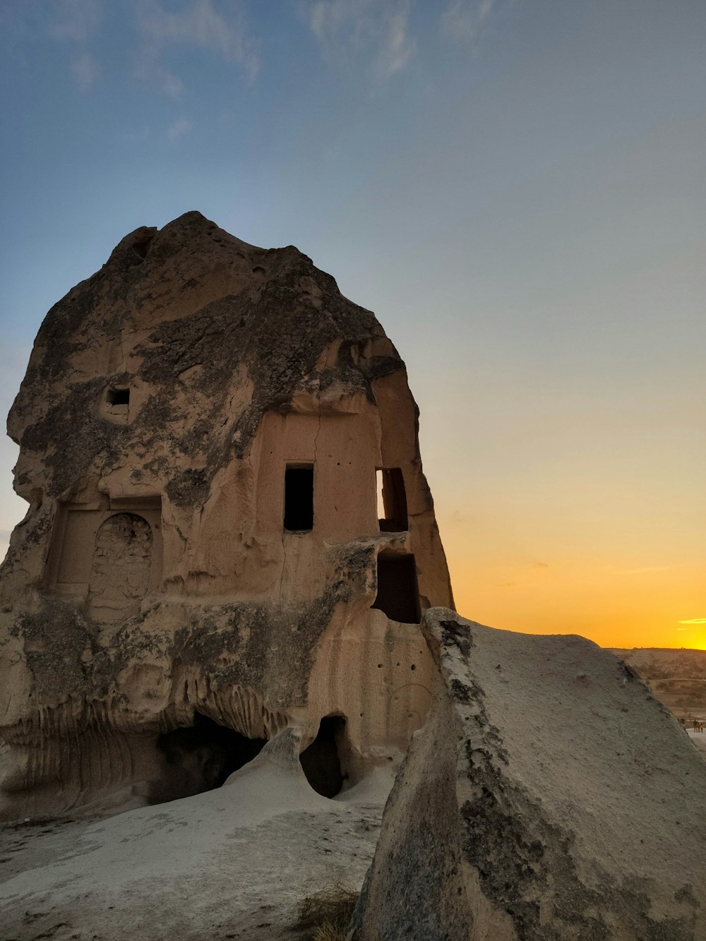 a rock formation with a cave in the middle of it