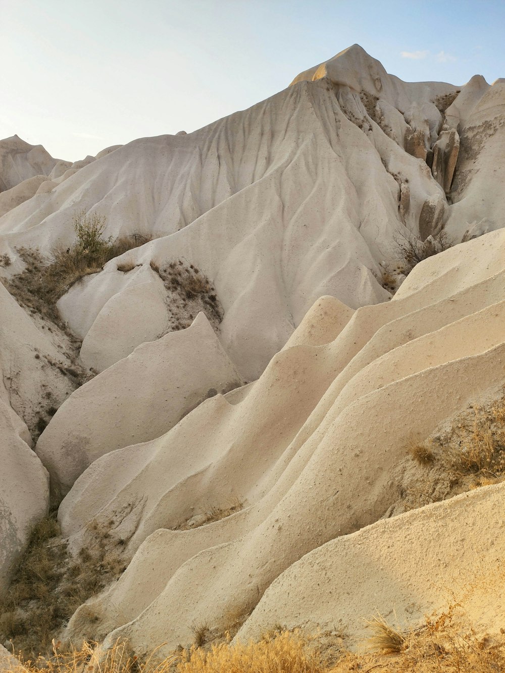 a view of a mountain range from the top of a hill