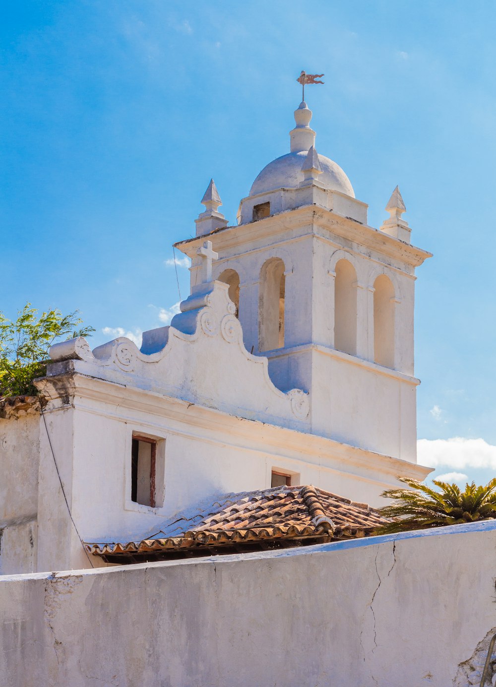 a white building with a clock on the top of it