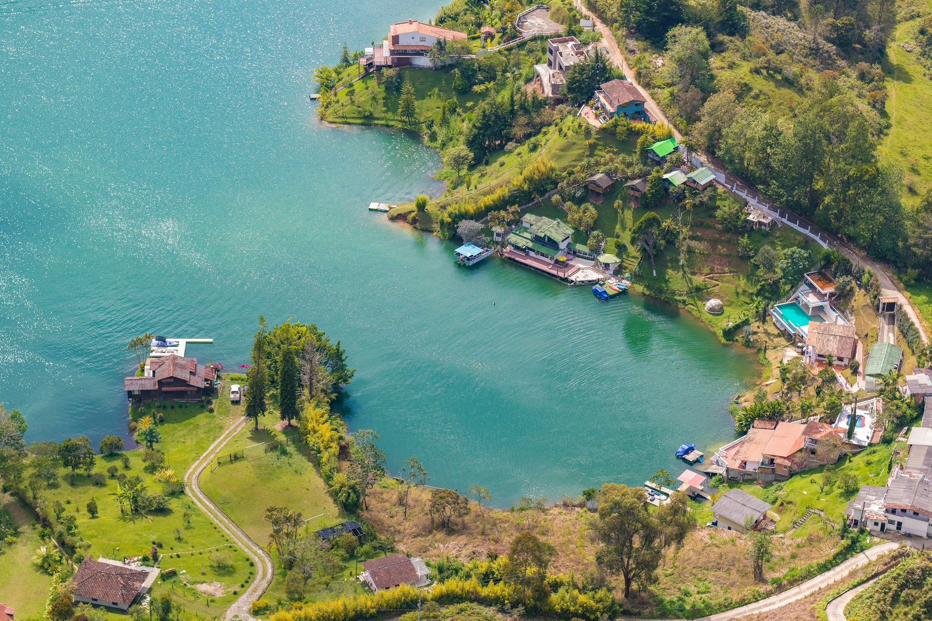 an aerial view of a lake surrounded by trees