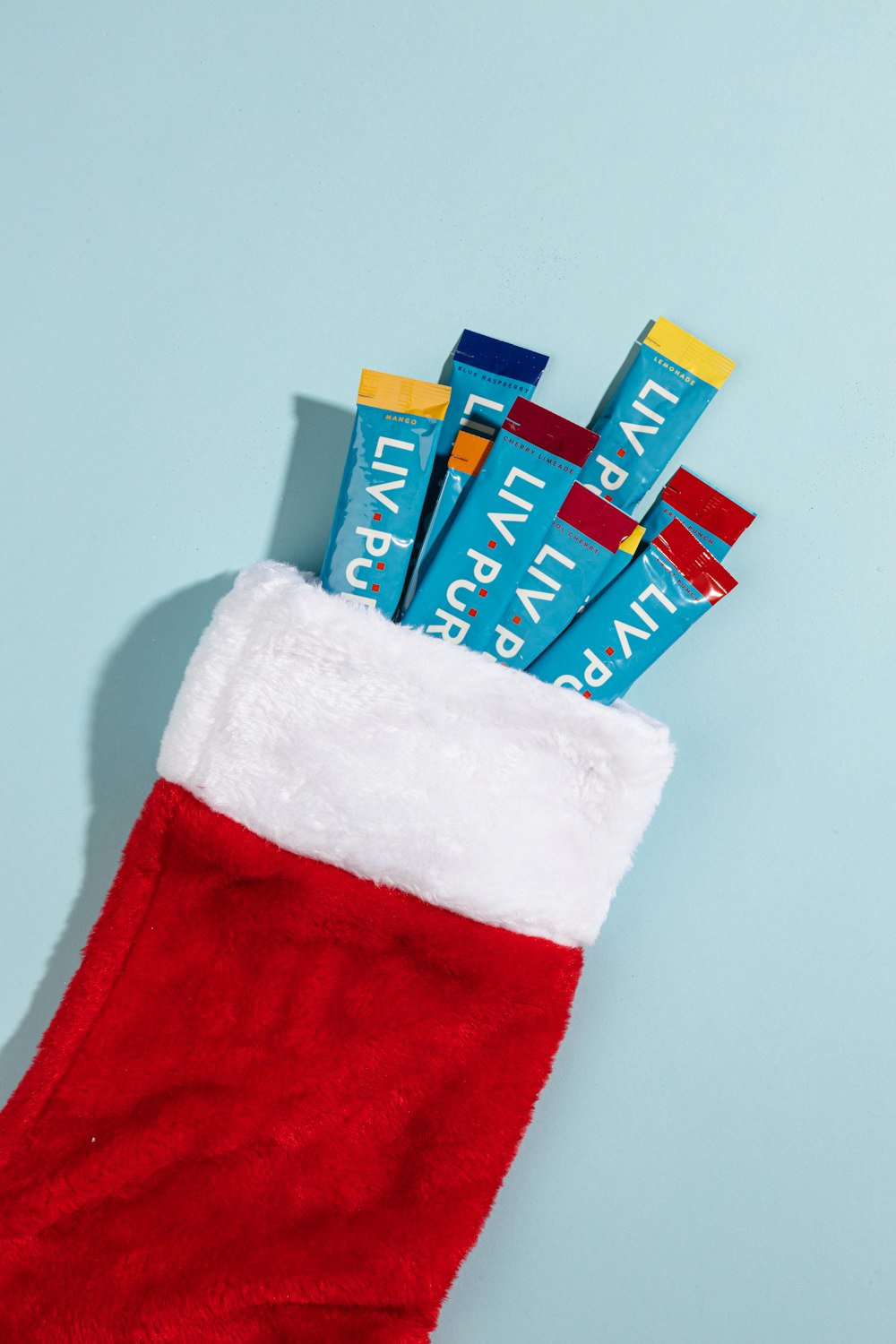 a stocking filled with toothbrushes sitting on top of a blue surface