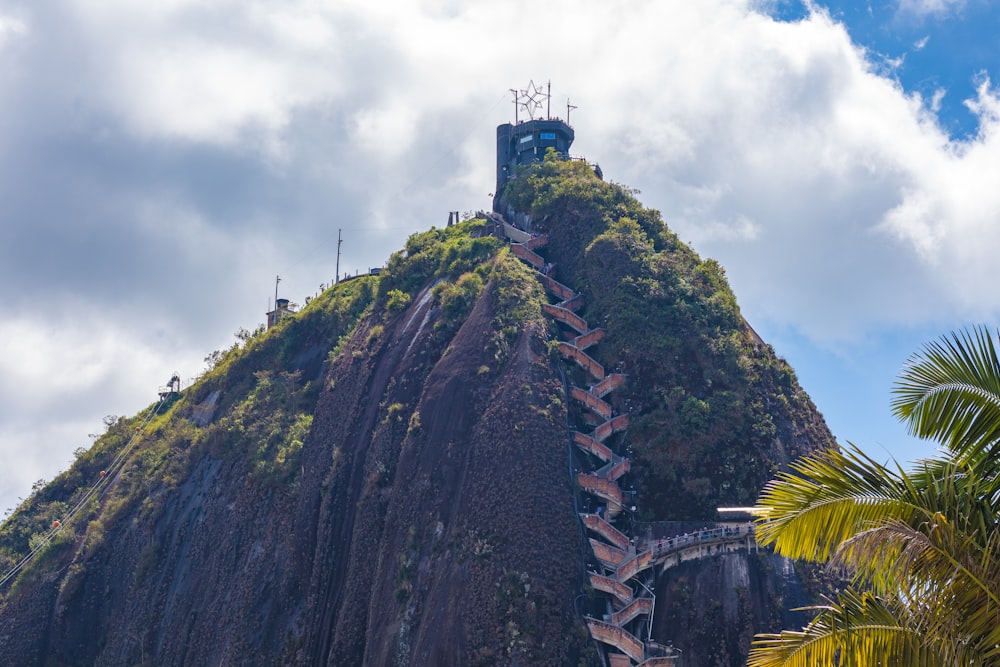 a very tall mountain with stairs going up it