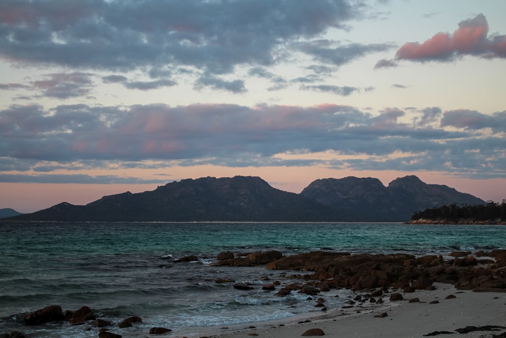 a view of a beach with mountains in the distance