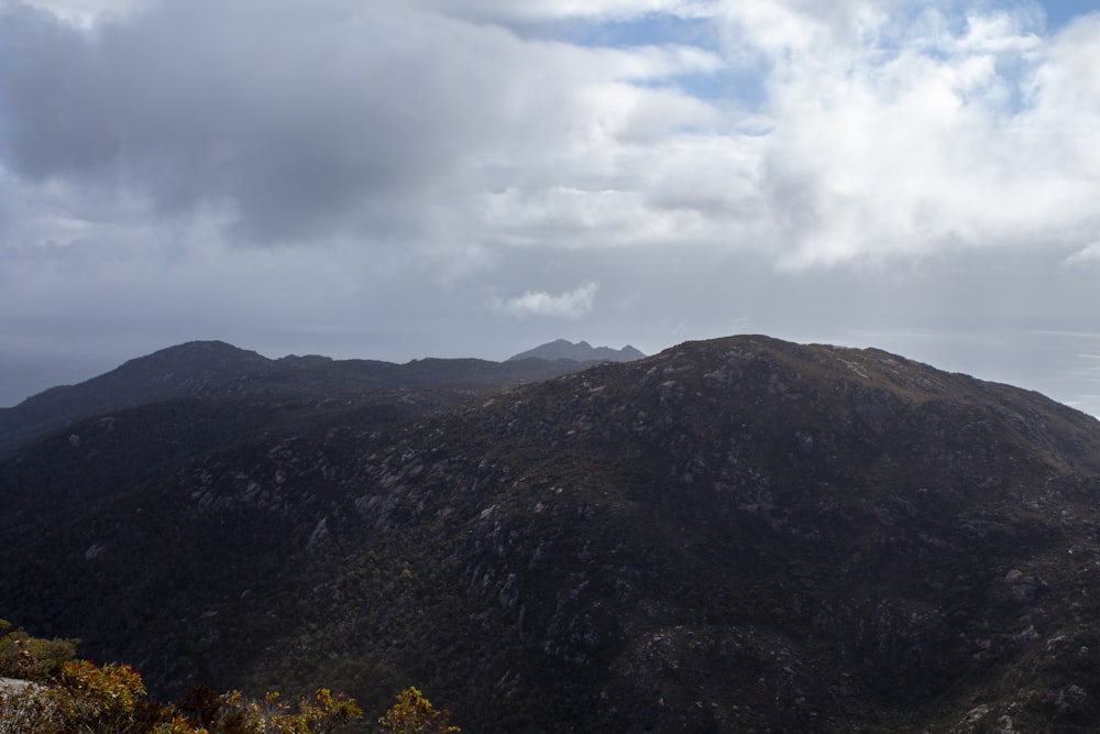 a view of a mountain range with clouds in the sky